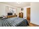 Cozy bedroom features a large window, hardwood floors, and plaid bedding for a relaxing retreat at 4585 Garrison St, Wheat Ridge, CO 80033