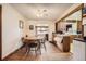 Cozy dining area with hardwood floors and classic wood furniture, flowing into the kitchen at 4585 Garrison St, Wheat Ridge, CO 80033