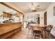 Cozy dining room with wood floors, traditional table, and views into the living room and kitchen at 4585 Garrison St, Wheat Ridge, CO 80033