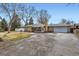 Charming single-story home with a brick exterior, attached garage and well-maintained grounds at 4585 Garrison St, Wheat Ridge, CO 80033