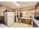 Vintage-style kitchen with patterned wallpaper and an adjacent dining area; bright and functional space at 4585 Garrison St, Wheat Ridge, CO 80033