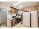 Functional kitchen with vintage wood cabinets, stainless steel appliances, and a classic tiled backsplash at 4585 Garrison St, Wheat Ridge, CO 80033