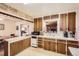 Charming kitchen featuring vintage wood cabinetry, bright tile countertops, and a classic double basin sink at 4585 Garrison St, Wheat Ridge, CO 80033