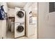 Convenient laundry room featuring stacked washer and dryer units with storage cabinets above at 4585 Garrison St, Wheat Ridge, CO 80033