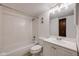 Neat bathroom featuring white tile, a vanity with storage, and a bathtub at 14192 E Colorado Dr # 102, Aurora, CO 80012