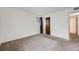 Simple bedroom with neutral carpet, a window, and a closet door at 14192 E Colorado Dr # 102, Aurora, CO 80012