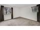 Spacious bedroom featuring neutral carpet, two windows, and ample natural light at 14192 E Colorado Dr # 102, Aurora, CO 80012