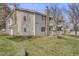 A charming condo with a stone chimney, two balconies, a well-kept lawn, and stairs to the upper level at 14192 E Colorado Dr # 102, Aurora, CO 80012