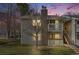 Charming condo with a stone chimney, two balconies, a well-kept lawn, and stairs to the upper level at 14192 E Colorado Dr # 102, Aurora, CO 80012