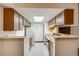 Efficient kitchen layout with ample cabinet space, a skylight, and essential appliances at 14192 E Colorado Dr # 102, Aurora, CO 80012