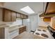 Bright kitchen with wood cabinets, essential appliances, and a practical design at 14192 E Colorado Dr # 102, Aurora, CO 80012
