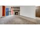 Bright living area featuring a fireplace, a sliding glass door with curtains, and views of the outside at 14192 E Colorado Dr # 102, Aurora, CO 80012