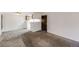 Spacious room featuring neutral walls, carpet, open access to the kitchen, and a ceiling fan at 14192 E Colorado Dr # 102, Aurora, CO 80012