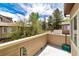 This balcony offers views of mature trees and blue skies, creating a serene outdoor space at 6001 S Yosemite St # B203, Greenwood Village, CO 80111