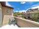 Private balcony with outdoor seating, offering views of trees and blue sky for relaxation at 6001 S Yosemite St # B203, Greenwood Village, CO 80111