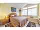 Serene bedroom with vaulted ceilings, a large window, and a decorative headboard at 6001 S Yosemite St # B203, Greenwood Village, CO 80111