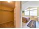Walk-in closet providing storage space with shelves and hanging rods, adjacent to bedroom at 6001 S Yosemite St # B203, Greenwood Village, CO 80111