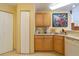 Kitchen offering light wood cabinets, a closet, and a bright decor at 6001 S Yosemite St # B203, Greenwood Village, CO 80111