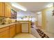 Open kitchen featuring warm cabinets, laminate countertops, and newer appliances at 6001 S Yosemite St # B203, Greenwood Village, CO 80111