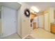Entry to kitchen with bright decor, closet, and appliances at 6001 S Yosemite St # B203, Greenwood Village, CO 80111