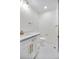 Modern bathroom with white vanity, gold hardware, and tiled shower at 6882 Quail St, Arvada, CO 80004