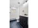 Modern bathroom featuring a sleek vanity, black hardware, and a tiled walk-in shower at 6882 Quail St, Arvada, CO 80004