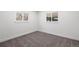 This bedroom features dual windows offering ample natural light and plush carpeting at 6882 Quail St, Arvada, CO 80004