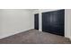Carpeted bedroom with a closet with double doors and neutral walls at 6882 Quail St, Arvada, CO 80004