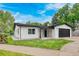 Charming one-story home featuring a stucco exterior, stone accents, a black roof, and an attached two-car garage at 6882 Quail St, Arvada, CO 80004