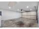 Spacious garage with an automatic door and concrete flooring, great for storage and parking at 6882 Quail St, Arvada, CO 80004