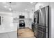 Kitchen area featuring stainless steel appliances and wood-look flooring at 6882 Quail St, Arvada, CO 80004