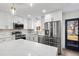 Bright kitchen has an island, stainless appliances, and ample counter space at 6882 Quail St, Arvada, CO 80004