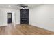 Empty living room shows fireplace, door, and wood-look flooring at 6882 Quail St, Arvada, CO 80004