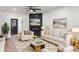 Staged living room with fireplace, white furniture, and art on the walls at 6882 Quail St, Arvada, CO 80004