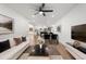 Living room with open floor plan, white sofa, and dining area at 6882 Quail St, Arvada, CO 80004
