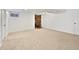 Finished basement area with a cozy, free-standing wood-burning fireplace with brick surround at 206 River Rd, Platteville, CO 80651