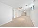 Expansive carpeted basement with multiple access doors, providing ample space for recreation or storage at 206 River Rd, Platteville, CO 80651