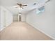 Large basement with neutral carpet, white walls, and two ceiling fans at 206 River Rd, Platteville, CO 80651