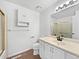 Clean bathroom featuring a white vanity, a framed mirror and a tiled shower at 206 River Rd, Platteville, CO 80651