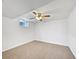 Carpeted bedroom featuring natural light from a window and a ceiling fan, ideal for relaxation at 206 River Rd, Platteville, CO 80651