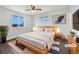 Cozy bedroom featuring a large window, wood frame bed and hardwood floors at 206 River Rd, Platteville, CO 80651