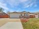 Charming ranch-style home featuring a brick facade, well-maintained lawn and an attached two-car garage at 206 River Rd, Platteville, CO 80651