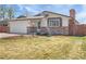 Charming single-story home featuring a well-manicured lawn and brick accents at 206 River Rd, Platteville, CO 80651