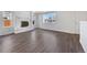 Bright living room featuring a cozy fireplace, hardwood floors, and large windows at 206 River Rd, Platteville, CO 80651