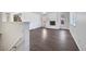 Bright living room with hardwood floors, white brick fireplace, and windows at 206 River Rd, Platteville, CO 80651