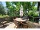 A cozy back deck features a round table with chairs and an umbrella at 5616 S Kenton Ct, Englewood, CO 80111