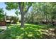 The backyard features a well-manicured lawn and a glimpse of the deck at 5616 S Kenton Ct, Englewood, CO 80111