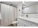 Bathroom featuring modern design, a black framed mirror, and neutral decor at 5616 S Kenton Ct, Englewood, CO 80111