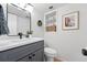 Updated bathroom with modern vanity, sleek fixtures, and decorative shelving at 5616 S Kenton Ct, Englewood, CO 80111