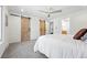 Bright bedroom featuring rustic sliding barn doors and soft, comfortable carpets at 5616 S Kenton Ct, Englewood, CO 80111